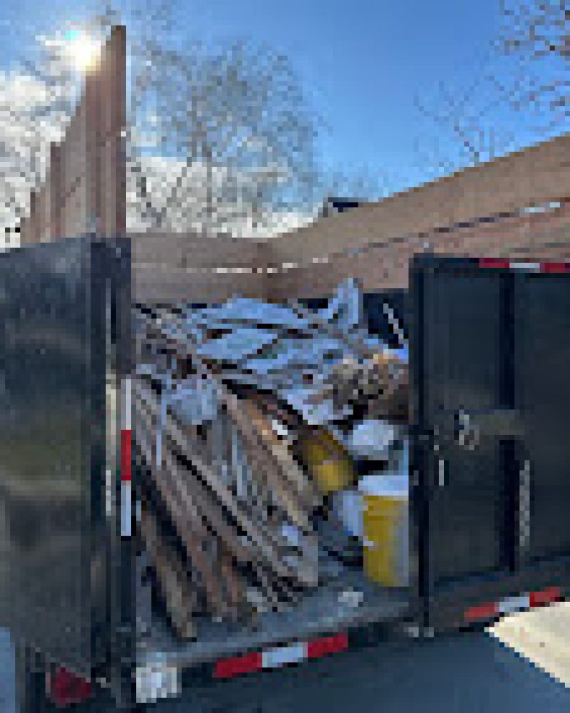 junk removal dump trailer loaded with junk