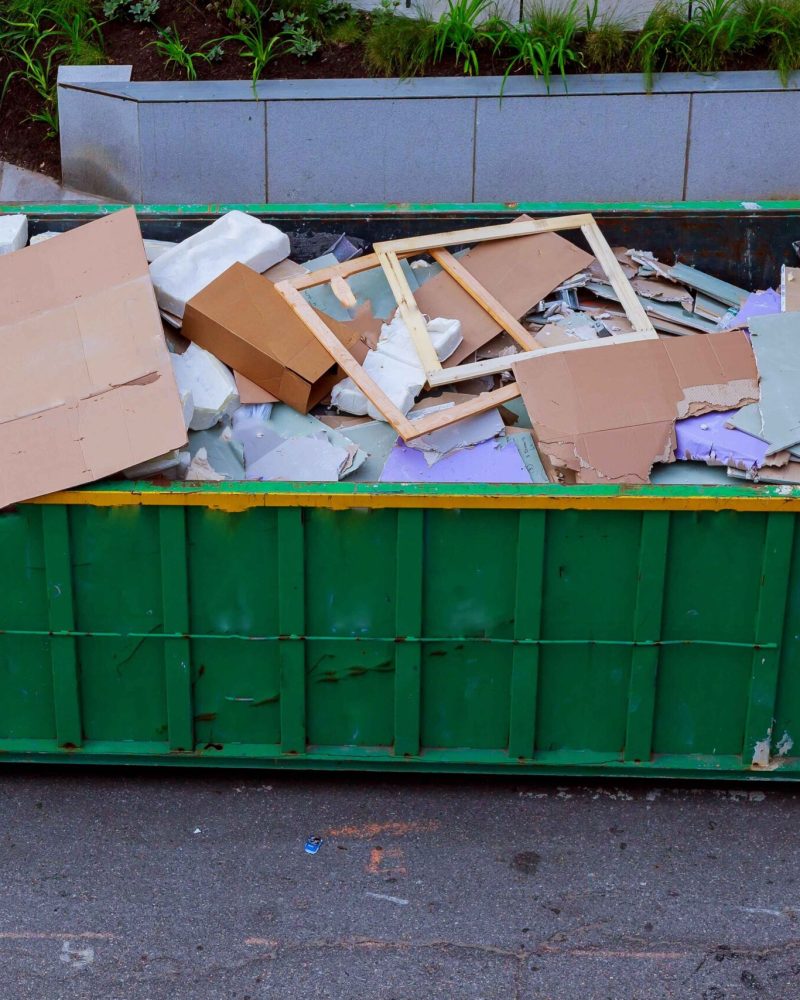 debris inside of 15 yard roll off dumpster